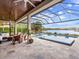 Covered patio with pool and spa overlooking lake at 19458 Beacon Park Pl, Lakewood Ranch, FL 34202
