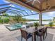 Covered patio with outdoor dining and a pool with a spa at 19458 Beacon Park Pl, Lakewood Ranch, FL 34202