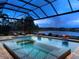 Resort-style pool and spa with a covered lanai overlooking a lake at 19458 Beacon Park Pl, Lakewood Ranch, FL 34202