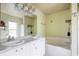 Bathroom with double vanity, bathtub, and shower at 20255 Macon Ln, Port Charlotte, FL 33952