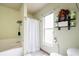 Bathroom with shower/tub combo and window at 20255 Macon Ln, Port Charlotte, FL 33952