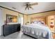Primary bedroom with a king-size bed, dresser, and ceiling fan at 20255 Macon Ln, Port Charlotte, FL 33952