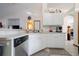 Kitchen with white cabinets, stainless steel dishwasher at 20255 Macon Ln, Port Charlotte, FL 33952