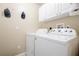 Laundry room with washer and dryer, and overhead cabinets at 20255 Macon Ln, Port Charlotte, FL 33952