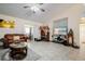 Spacious living room with a fireplace, large TV, and comfy leather couches at 20255 Macon Ln, Port Charlotte, FL 33952