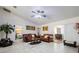Open living area features two leather sofas and a view of the dining area at 20255 Macon Ln, Port Charlotte, FL 33952