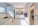 A luxurious bathroom with dual sinks, decorative tiling, soaking tub, and walk-in closet access at 219 Heritage Isles Way, Bradenton, FL 34212