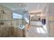 A well-lit bathroom featuring a walk-in shower, soaking tub, and elegant vanity with dual sinks at 219 Heritage Isles Way, Bradenton, FL 34212