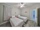 A cozy bedroom featuring two twin beds, neutral color palette, and an en suite bathroom at 219 Heritage Isles Way, Bradenton, FL 34212