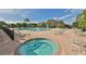 Resort-style community pool with a hot tub, lounge chairs, and mature landscaping at 219 Heritage Isles Way, Bradenton, FL 34212