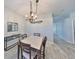 Open dining room featuring wood-look floors, a stylish chandelier, and modern decor at 219 Heritage Isles Way, Bradenton, FL 34212