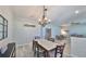 Bright dining room with a decorative chandelier, wood-look floors, and a view to the living room at 219 Heritage Isles Way, Bradenton, FL 34212