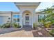 Inviting entrance with front porch, meticulously maintained landscaping, and warm curb appeal at 219 Heritage Isles Way, Bradenton, FL 34212