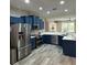 A kitchen with stainless steel appliances, white countertops, and a view into the living space at 219 Heritage Isles Way, Bradenton, FL 34212