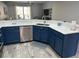 Updated kitchen featuring stainless steel appliances, and light countertops with blue cabinets at 219 Heritage Isles Way, Bradenton, FL 34212