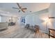 Spacious living room with wood-look floors connecting to the dining area for seamless entertaining at 219 Heritage Isles Way, Bradenton, FL 34212