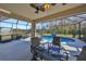 Relaxing screened in pool and patio area with outdoor seating, fan and lighting at 219 Heritage Isles Way, Bradenton, FL 34212