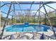 A tranquil screened pool with a decorative water feature and comfortable lounge seating at 219 Heritage Isles Way, Bradenton, FL 34212