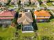 Aerial view of a home with a screened pool area, mature landscaping, and tile roof at 219 Heritage Isles Way, Bradenton, FL 34212