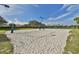 A community sand volleyball court offers recreation with a scenic view of a lake in the background at 219 Heritage Isles Way, Bradenton, FL 34212
