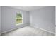 Simple bedroom with grey walls and a window overlooking the street at 22402 Peachland Blvd, Port Charlotte, FL 33954