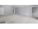 Open living space with grey carpet and access to other rooms at 22402 Peachland Blvd, Port Charlotte, FL 33954