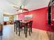 Charming dining area with red accent wall and wood floors at 2523 Darwin Ave, Sarasota, FL 34239