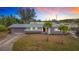 Updated ranch home with a landscaped yard and driveway at 2523 Darwin Ave, Sarasota, FL 34239