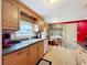 View of kitchen with wood cabinets, granite counters and breakfast nook at 2523 Darwin Ave, Sarasota, FL 34239