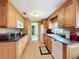 Kitchen with wood cabinets, granite counters, and modern appliances at 2523 Darwin Ave, Sarasota, FL 34239