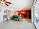 Open living area with red accent wall and access to patio at 2523 Darwin Ave, Sarasota, FL 34239