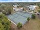 Community tennis court with surrounding trees and landscaping at 3250 Ramblewood Cir, Sarasota, FL 34237