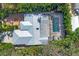 Aerial view of home with metal roof, pool, and lush landscaping at 3414 Old Oak Dr, Sarasota, FL 34239