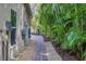 A brick pathway leads through a beautifully landscaped backyard at 3414 Old Oak Dr, Sarasota, FL 34239