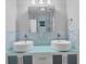 Modern bathroom with dual sinks, glass counter, and blue tile backsplash at 3414 Old Oak Dr, Sarasota, FL 34239