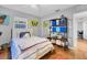 Charming bedroom with terracotta floors, butterfly art, and built-in shelving at 3414 Old Oak Dr, Sarasota, FL 34239