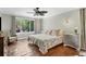 Comfortable bedroom with terracotta floors, large window, ceiling fan, and plenty of light at 3414 Old Oak Dr, Sarasota, FL 34239