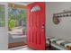 Bright entryway with red door and built-in bench at 3414 Old Oak Dr, Sarasota, FL 34239