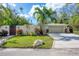 Modern home with attached garage and tropical landscaping at 3414 Old Oak Dr, Sarasota, FL 34239