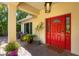 Inviting front entrance with red door and potted plants at 3414 Old Oak Dr, Sarasota, FL 34239