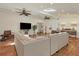 Large living room with sectional sofa and terracotta floors at 3414 Old Oak Dr, Sarasota, FL 34239