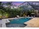 Enjoy this luxurious screened pool and patio at night at 3414 Old Oak Dr, Sarasota, FL 34239