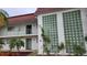 Condo building entryway, featuring a unique wall design and landscaping at 3606 Beneva Rd # 502, Sarasota, FL 34232