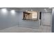Open living room with kitchen views, tiled floors, and an accent wall at 3606 Beneva Rd # 502, Sarasota, FL 34232