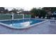 Community pool with surrounding patio furniture and brick pavers at 3606 Beneva Rd # 502, Sarasota, FL 34232