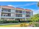 Two-story condo building with balconies and lush landscaping at 3801 E Bay Dr # 209, Holmes Beach, FL 34217