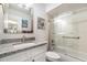Bathroom with granite countertop, single sink, bathtub, and shower at 3920 Bal Harbor Blvd # E1, Punta Gorda, FL 33950