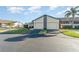 Two-car garage with a condo unit, well-maintained lawn, and landscaping at 3920 Bal Harbor Blvd # E1, Punta Gorda, FL 33950