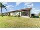 Condo showcasing a screened-in patio and lush lawn at 3920 Bal Harbor Blvd # E1, Punta Gorda, FL 33950