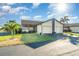 Two-car garage and front entrance of a condo with nicely landscaped lawn at 3920 Bal Harbor Blvd # E1, Punta Gorda, FL 33950